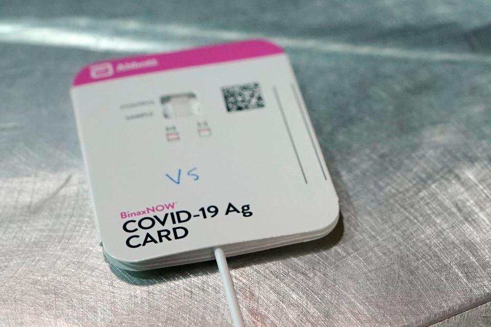 A BinaxNOW rapid COVID-19 test made by Abbott Laboratories rests on a table in the room where student-athletes at Pacific Lutheran are tested three times a week, Wednesday, Feb. 3, 2021, in Tacoma, Wash.