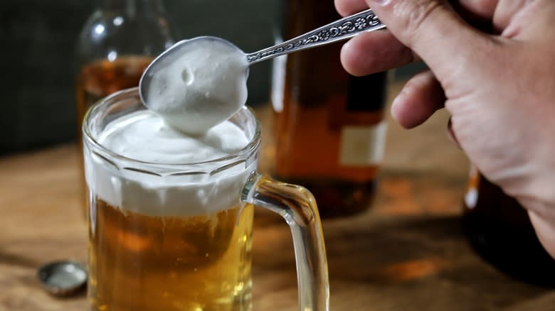 topping butterbeer with whipped cream