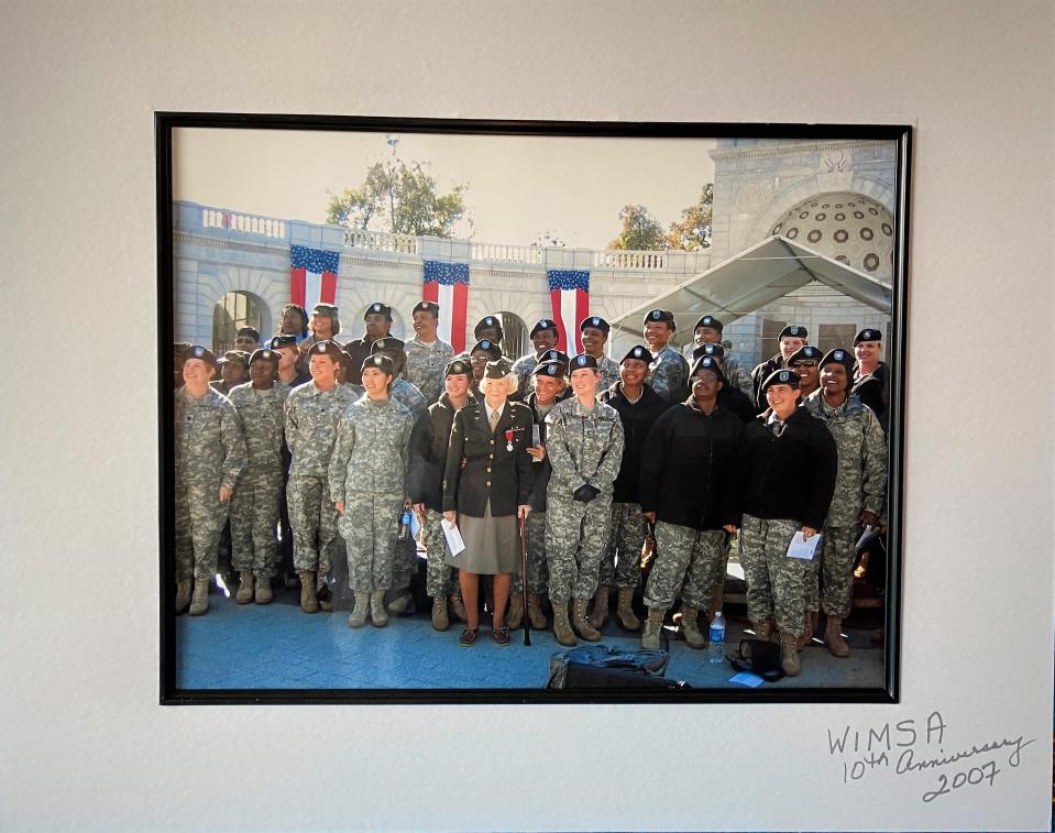 Kate Flynn Nolan, center, is surrounded by Army nurses and other soldiers at the Women in Military Service for America Memorial in Washington, D.C., in 2007.