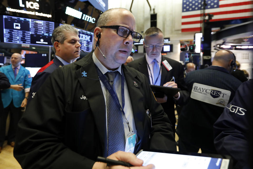 Trader Jeffrey Vazquez works on the floor of the New York Stock Exchange, Wednesday, June 19, 2019. Investors are in wait-and-see mode hours ahead of a widely anticipated Federal Reserve decision on interest rates. (AP Photo/Richard Drew)