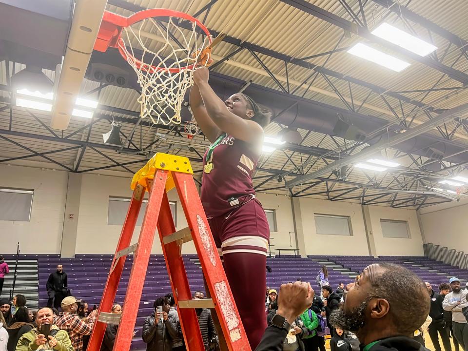 Harvest Prep’s Maliyah Lofton cuts a piece of the net as Harvest Prep celebrates its Division III district title Thursday at Capital.