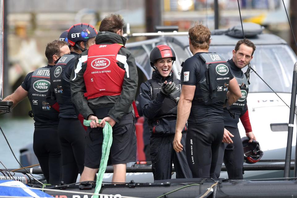 <p>The Duchess has a laugh with sailors onboard the Land Rover training boat in Portsmouth, England. </p>