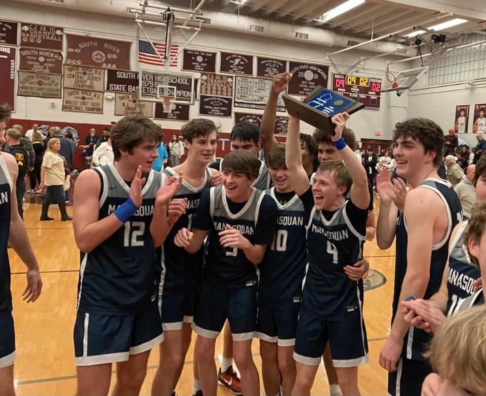 Manasquan players celebrate a 60-52 victory over South River in the NJSIAA Central Group 2 final in South River on Feb. 28, 2023.