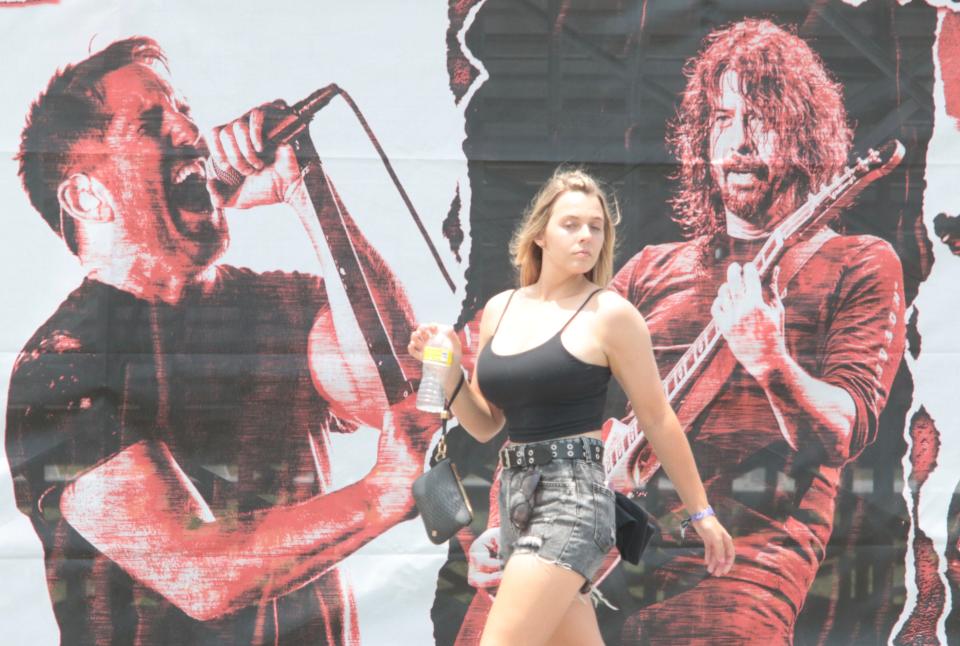 A fan strolls past one of the colorful murals as Welcome to Rockville opened its gates at Daytona International Speedway on Thursday.