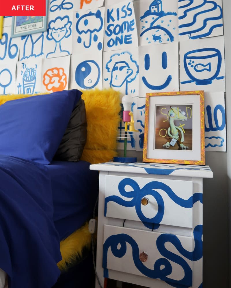 "After" photo of a bed and wall/s after makeover. Wall is covered with white "notes" and drawings (in blue). Bed has gold fuzzy headboard, navy blue pillows.