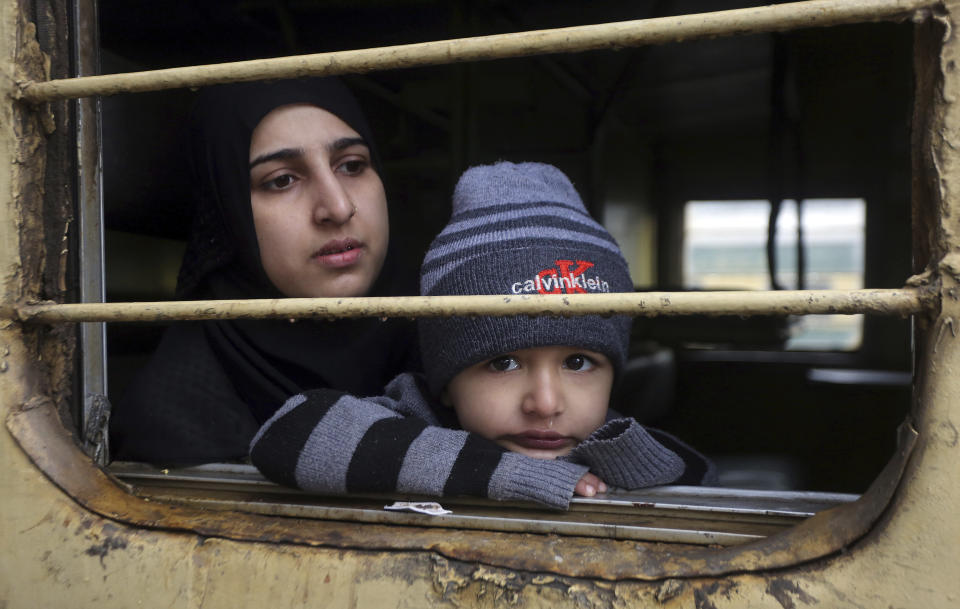 A passenger looks out from a train on her way to India, after being stranded in Pakistan for a week, at Lahore Railway Station in Pakistan, Monday, March 4, 2019. A Pakistani railways official says a key train service between Pakistan and neighbouring India has been resumed, a sign on easing tensions between the two South Asian nuclear-armed rivals. (AP Photo/K.M. Chaudary)