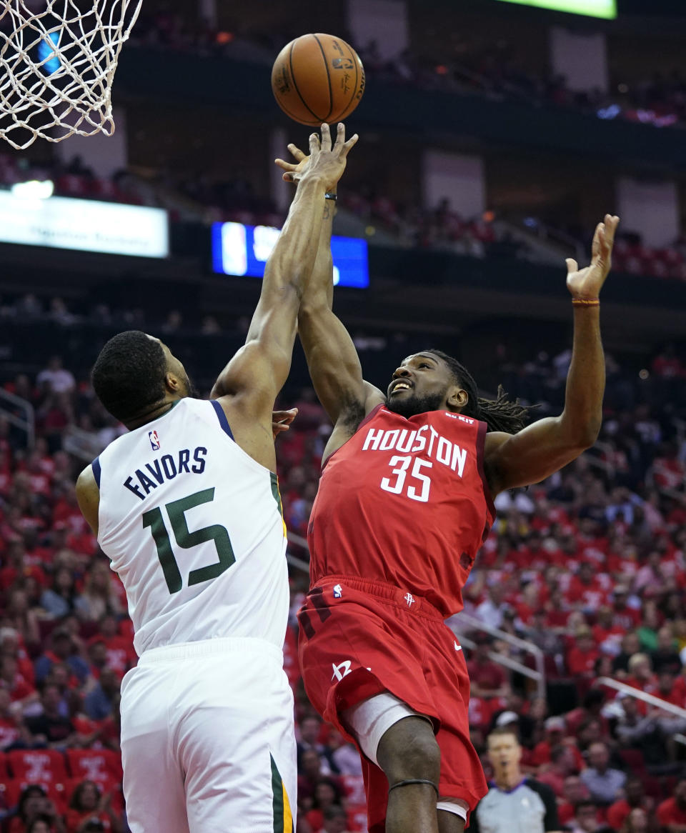 Houston Rockets forward Kenneth Faried (35) is blocked by Utah Jazz forward Derrick Favors (15) during the first half in Game 5 of an NBA basketball playoff series, in Houston, Wednesday, April 24, 2019. (AP Photo/David J. Phillip)