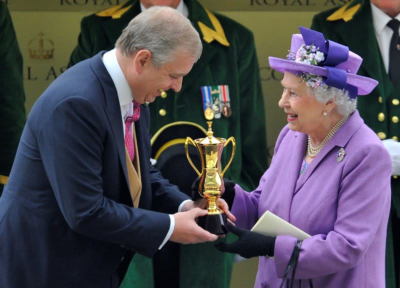 FILE PHOTO: Britain's Queen Elizabeth smiles as she is presented with The Gold Cup by her son Prince Andrew after her horse Estimate won the feature race during ladies day at the Royal Ascot horse racing festival at Ascot