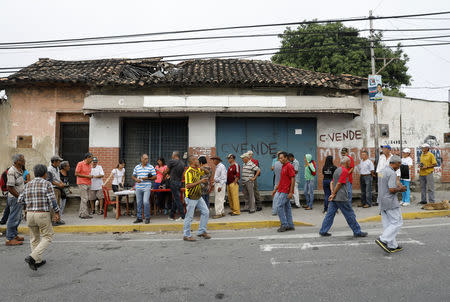 Venezuelan citizens check in at a "Red Point," an area set up by President Nicolas Maduro's party, to verify that they cast their votes during the presidential election in Caracas, Venezuela, May 20, 2018. REUTERS/Carlos Jasso