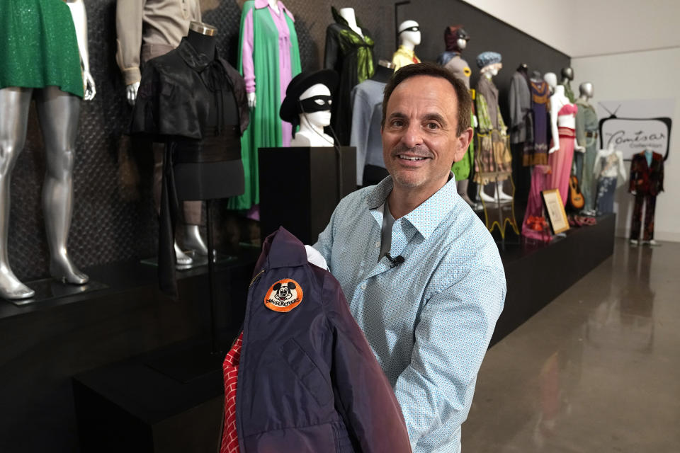 James Comisar holds the jacket worn by Annette Funicello on "The Mickey Mouse Club", Thursday, April 27, 2023, in Irving, Texas. A dizzying number of props, sets, and costumes from television shows beloved by generations of viewers will be sold at auction next month. The collection James Comisar has spent over 30 years amassing includes "The Tonight Show" set Johnny Carson gave him after retiring, the timeworn living room from "All in the Family," and the bar where Sam Malone served customers on Cheers. (AP Photo/Tony Gutierrez)