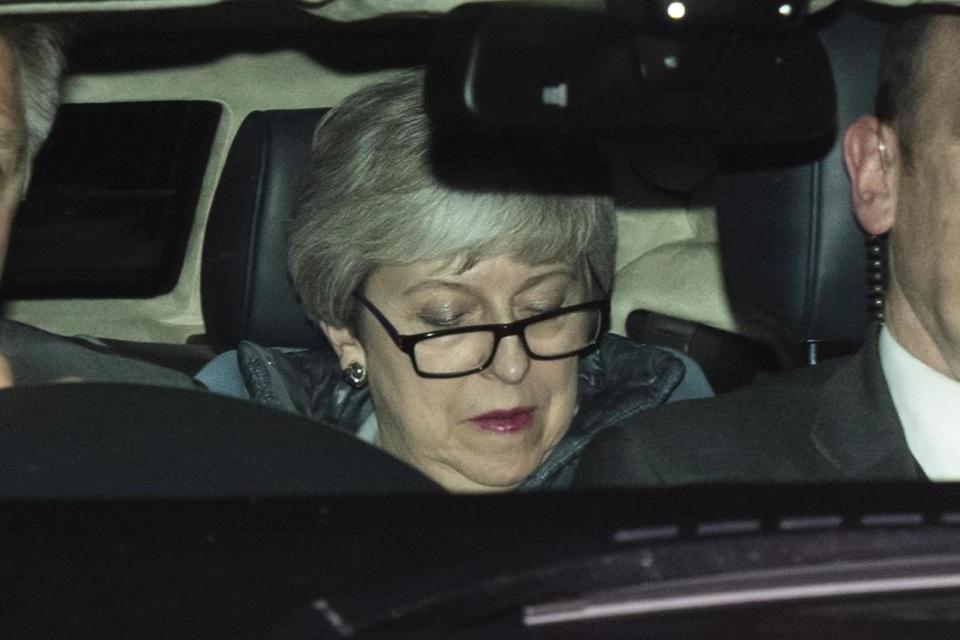 Under pressure: Theresa May leaves the Commons on Monday night (EPA)