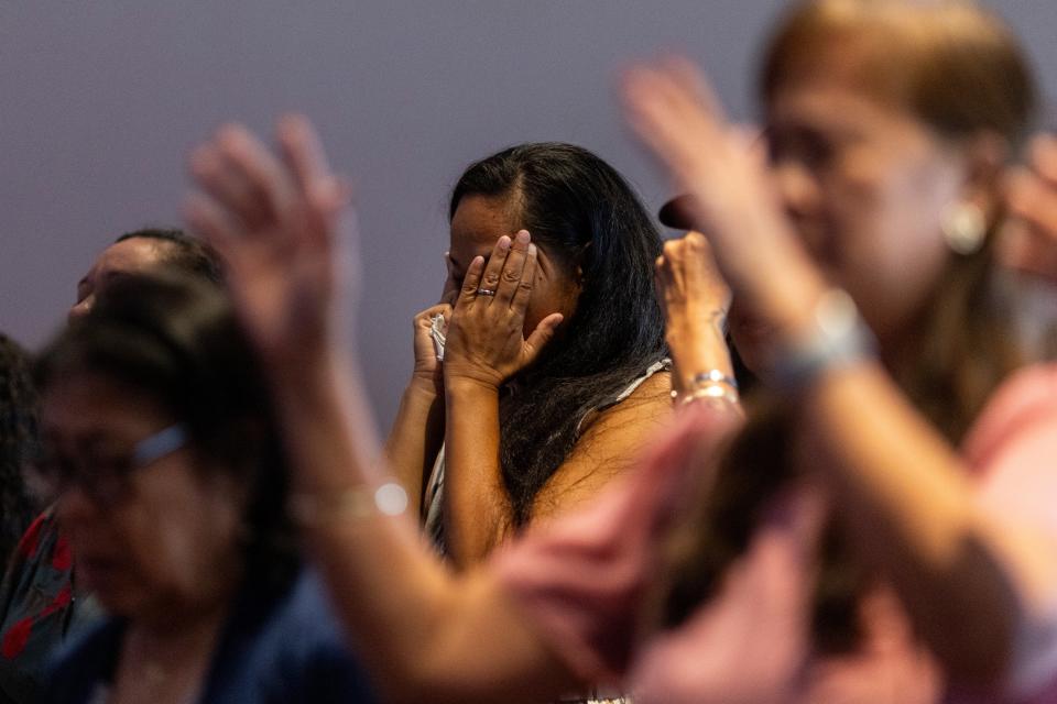 An attendee is overcome with emotions during a church service at King’s Cathedral in Kahului on the island of Maui (San Francisco Chronicle)