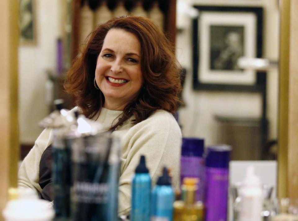 In this Thursday, Dec. 29, 2016, photo, Karen Gordon sits in a chair at J. Gordon Designs in Chicago. The state law requiring one hour of abuse-prevention training for stylists, barbers, cosmetologists, estheticians, hair braiders and nail technicians as part of the licensing process goes into effect Sunday, Jan. 1. The National Conference of State Legislatures says the Illinois measure appears to be the first of its kind in the country. (AP Photo/Nam Y. Huh)