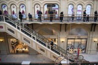 People queue to get a shot of Russia's Sputnik V coronavirus vaccine at a vaccination center in GUM State Department store in Moscow, Russia, Wednesday, Jan. 20, 2021. Russia started a mass coronavirus vaccination campaign on Monday. (AP Photo/Pavel Golovkin)