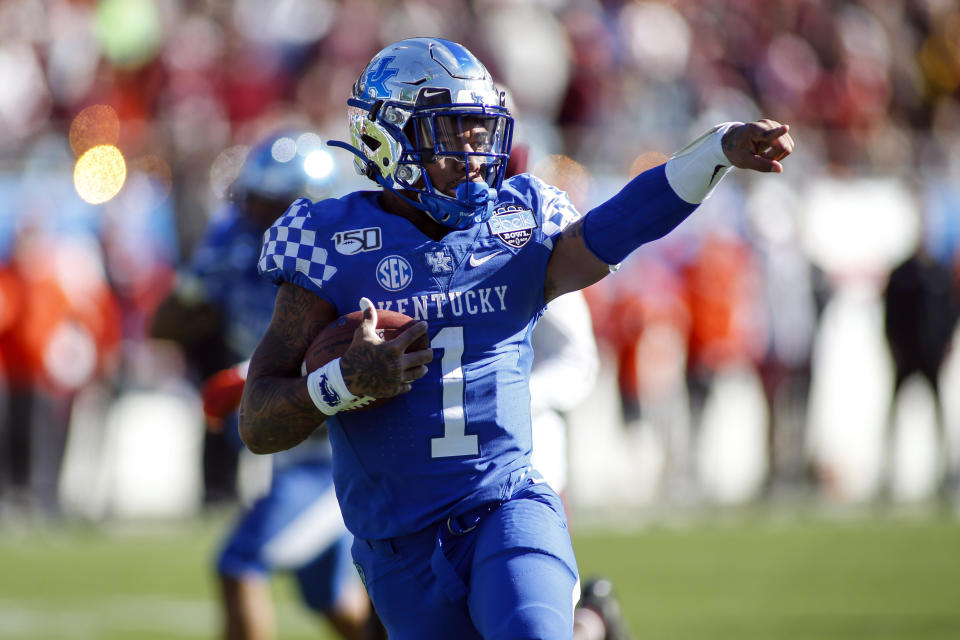 Kentucky quarterback Lynn Bowden Jr. (1) celebrates as he runs 25-yards for a touchdown against Virginia Tech in the first half of the Belk Bowl NCAA college football game in Charlotte, N.C., Tuesday, Dec. 31, 2019. (AP Photo/Nell Redmond)