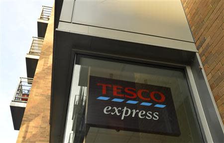 A Tesco logo is seen on a branch of the Tesco Express convenience store below a residential building in central London December 12, 2013. REUTERS/Toby Melville