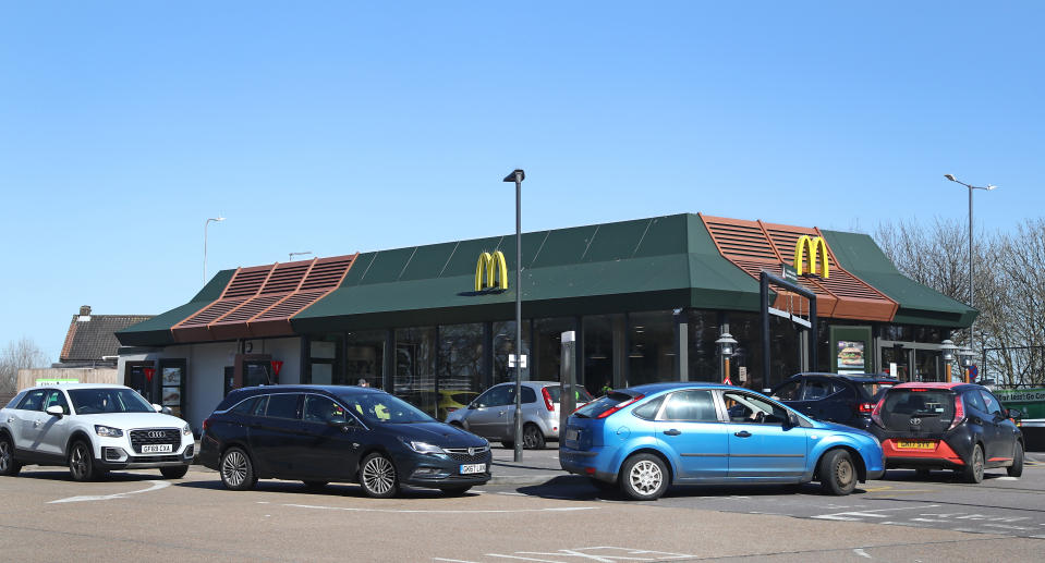 Drivers form a long queue to use a McDonald's drive-thru near Dover in Kent as it was announced that all of their restaurant locations in the UK and Ireland will close by 7pm on Monday to protect the safety of their employees and customers from coronavirus.