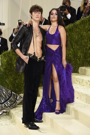 A man and woman dressed up while standing on steep stairs