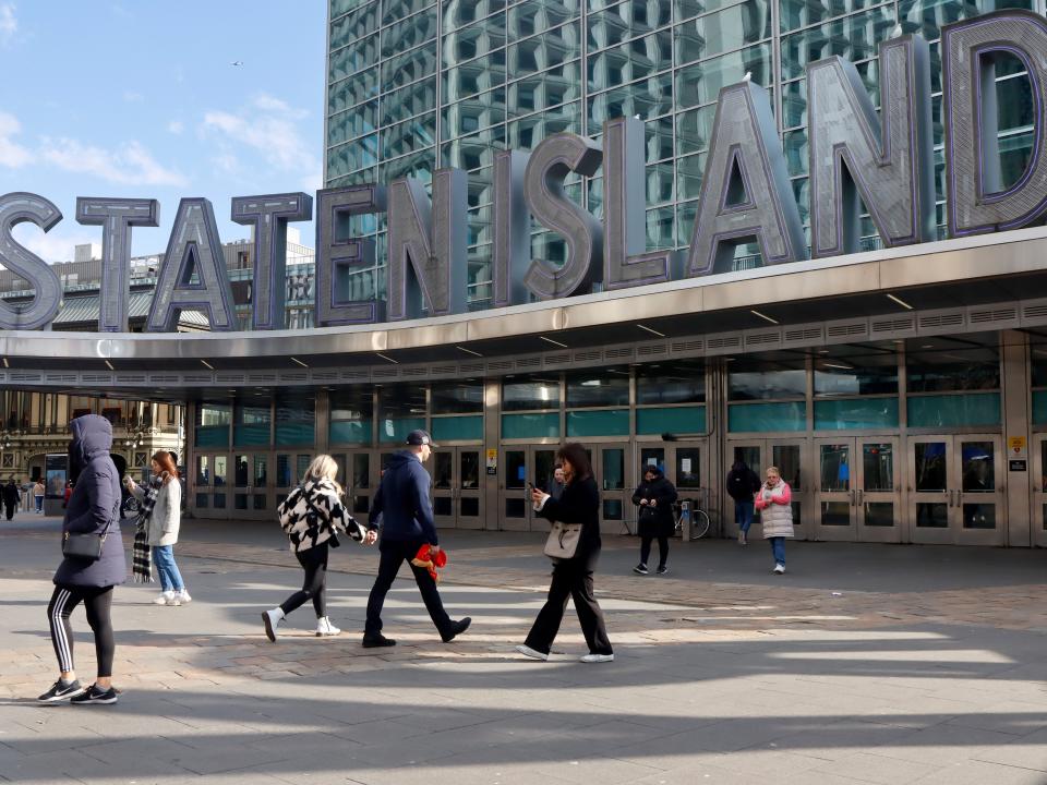 People walk into the Manhattan Staten Island Ferry Terminal on March 5, 2023, in New York City.