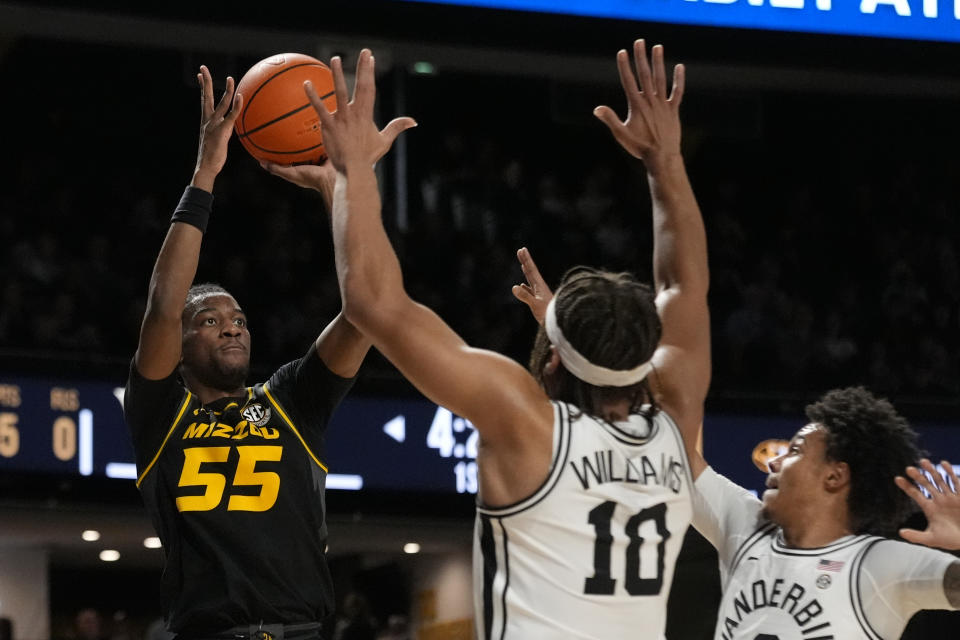 Missouri guard Sean East II (55) shoots over Vanderbilt guard Jordan Williams (10) and guard Tyrin Lawrence, right, during the first half of an NCAA college basketball game Saturday, Feb. 3, 2024, in Nashville, Tenn. (AP Photo/George Walker IV)