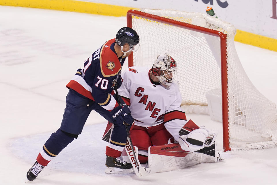 Carolina Hurricanes goaltender James Reimer (47) grabs the puck from a shot by Florida Panthers right wing Patric Hornqvist (70) during the second period at an NHL hockey game, Saturday, Feb. 27, 2021, in Sunrise, Fla. (AP Photo/Marta Lavandier)