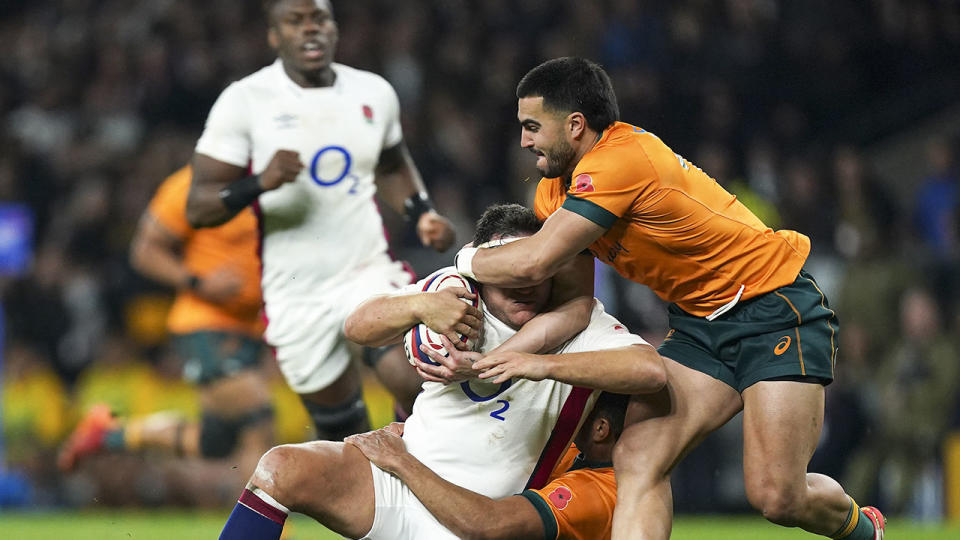 Pictured here, Wallabies star Tom Wright tackles an England player high in the Twickenham Test match.