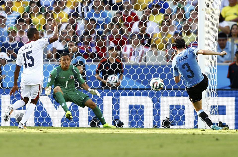 Uruguay's Diego Godin (R) is caught offside during their 2014 World Cup Group D soccer match against Costa Rica at the Castelao arena in Fortaleza June 14, 2014. (Marcelo Del Pozo/Reuters)