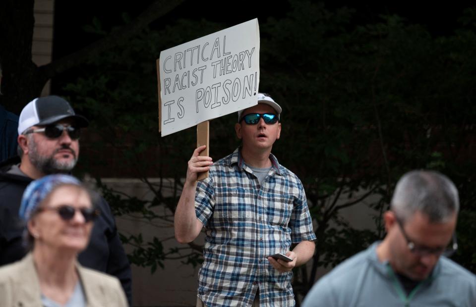 A protester holding a sign saying 