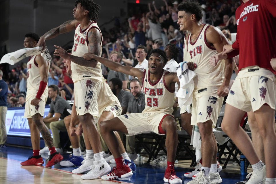 Florida Atlantic guard Brandon Weatherspoon (23) reacts along with teammates on the bench during the second half of the team's NCAA college basketball game against Eastern Michigan, Tuesday, Nov. 14, 2023, in Boca Raton, Fla. (AP Photo/Rebecca Blackwell)