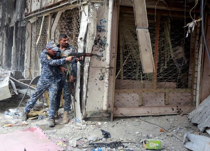 A member of the Iraqi Federal Police opens fire against Islamic State militants in the Old City of Mosul, Iraq July 7, 2017. REUTERS/Ahmed Saad