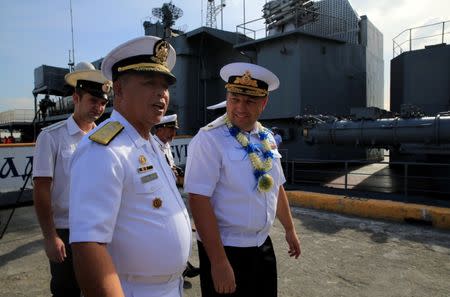 Rear Admiral Eduard Mikhailov (R), the deputy commander of Flotilla of Pacific Fleet of Russia, and Commodore Francisco Gabidao, the Philippine naval combat engineering brigade, walk past the Russian Navy vessel, Admiral Tributs, a large anti-submarine ship, as it docks at the south harbor port area in metro Manila, Philippines January 3, 2017. REUTERS/Romeo Ranoco