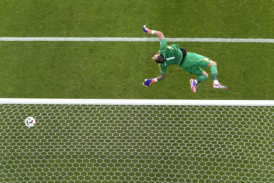 Italy's goalkeeper Gianluigi Donnarumma fails to safe a shot on goal by Switzerland's Ruben Vargas during a round of sixteen match between Switzerland and Italy at the Euro 2024 soccer tournament in Berlin, Germany, Saturday, June 29, 2024. (AP Photo/Markus Schreiber)