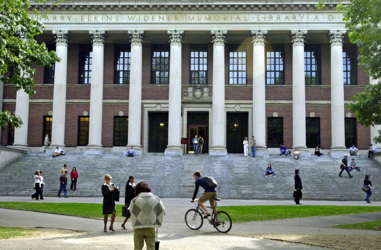 Students pass Harvard's Widener Library in a scene that already feels nostalgic. (William B. Plowman/Getty Images)