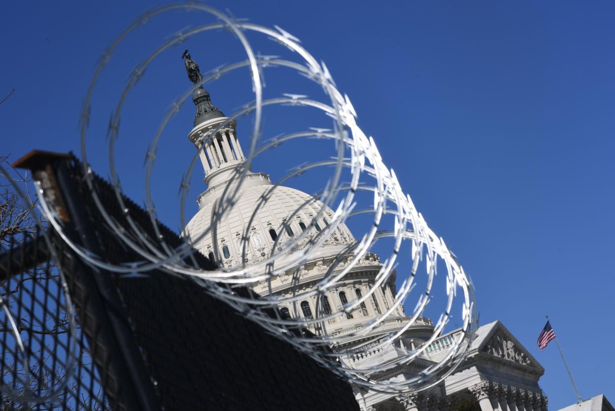 A barbed wire-topped fence has surrounded the Capitol since the insurrection in January. (AFP via Getty Images)