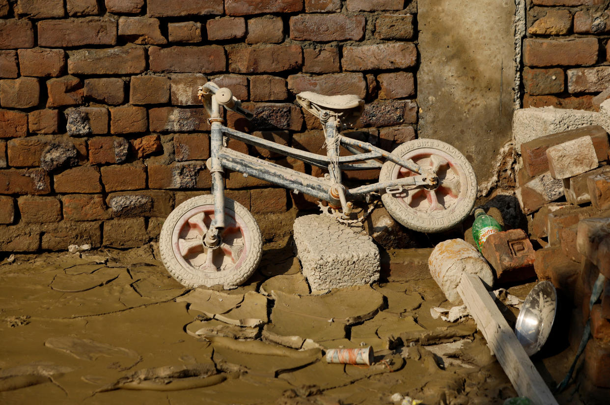 Belongings left to dry in a house after flood water receded in Nowshera
