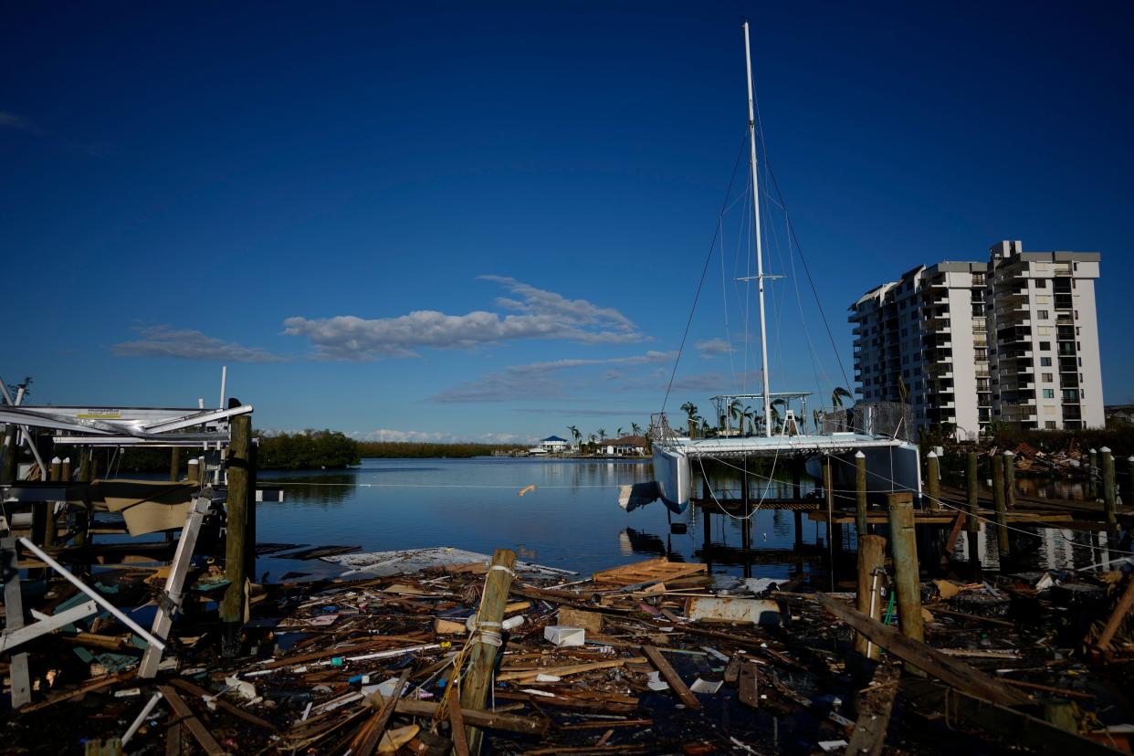 A catamaran rests atop a dock in Getaway Marina, which was destroyed during the passage of Hurricane Ian, on San Carlos Boulevard in Fort Myers Beach, Fla., Sunday, Oct. 2, 2022.