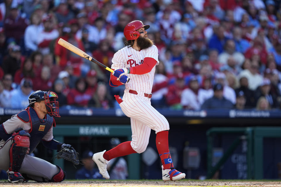 Philadelphia Phillies' Brandon Marsh follows through after hitting a two-run home run against Atlanta Braves pitcher Spencer Strider during the fifth inning of an opening-day baseball game, Friday, March 29, 2024, in Philadelphia. (AP Photo/Matt Slocum)