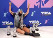 <p>The singer celebrated her multiple award wins in a MTV-branded T-shirt, studded mask and uber-platform boots. </p>