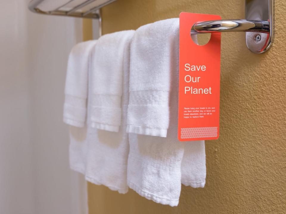 A sign encourages guests to reuse bath towels.