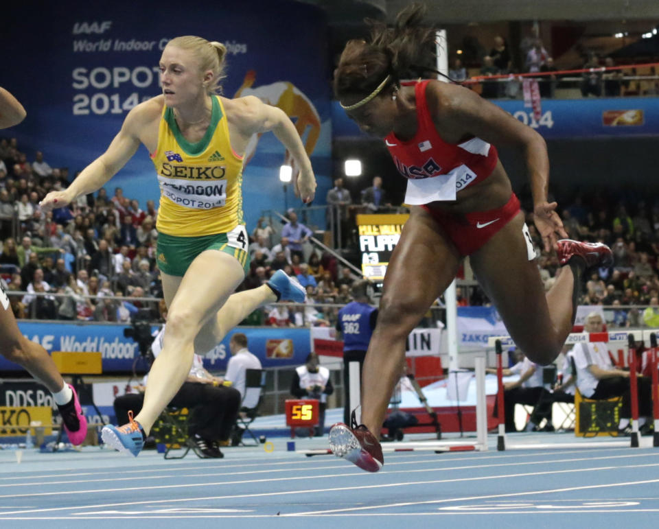 Australia's silver medal winner Sally Pearson, left, and United States' gold medal winner Nia Ali cross the line of the women's 60m hurdles final during the Athletics Indoor World Championships in Sopot, Poland, Saturday, March 8, 2014. (AP Photo/Matt Dunham)