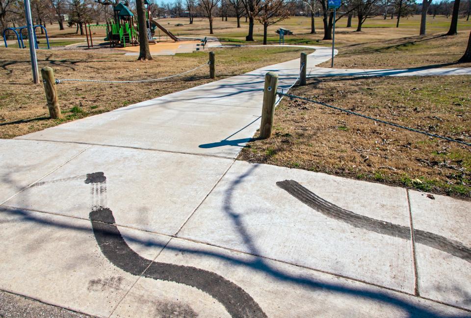 Tire burnout marks are seen Friday on a sidewalk at Rotary Park in Oklahoma City.