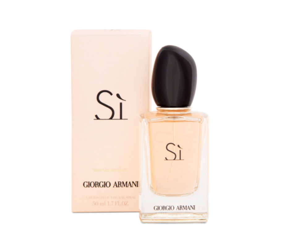 Giorgio Armani's Si fragrance in a pale pink box on the left with the  pale pink glass bottle on the right with a black lid against a white background.