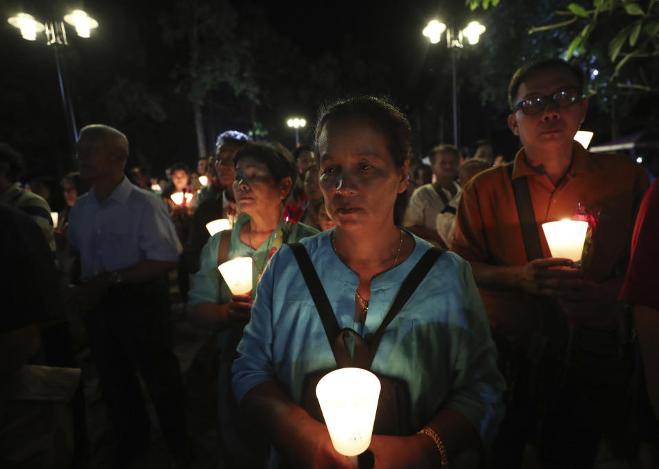 In this Friday, Oct. 18, 2019, photo, Catholic devotees hold candles during the 30th anniversary of the beatification of seven martyrs at Songkhon village in Mukdahan province, northeastern Thailand. In 1940, seven villagers here were executed for refusing to abandon their Catholic faith, which Thai nationalists had equated with loyalty to France, whose colonial army in neighboring Indochina had fought Thailand in a brief border war. The seven were beatified in 1989 by Pope John Paul II, the first step to being named a saint. (AP Photo/Sakchai Lalit)