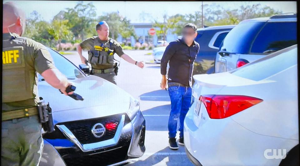 In this photo of a video, Flagler County Sheriff's Office deputies arrest a man in the shoplifting of more than $1,000 worth of shaving razors from the Target in Palm Coast in this photo of a scene in "Police 24/7" on The CW channel.
