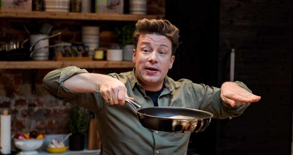 The British chef Jamie Oliver cooks at the One Kitchen Culinary School in Hamburg, Germany, 6 December 2017. Oliver also presented his book "5 Ingredients - Quick & Easy Food recipes". Photo: Axel Heimken/dpa (Photo by Axel Heimken/picture alliance via Getty Images)