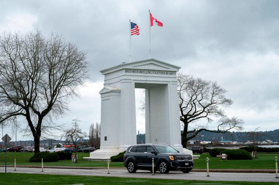 People cross the border between the U.S. and Canada at Peace Arch Park on Friday, March 18, 2022, in Blaine, Wash. Warren Sterling/The Bellingham Herald