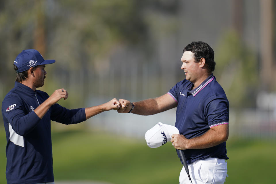 Patrick Reed, right, greets Rickie Fowler after the two finished on the ninth hole of the North Course during the first round of the Farmers Insurance Open golf tournament at Torrey Pines on Thursday, Jan. 28, 2021, in San Diego. (AP Photo/Gregory Bull)