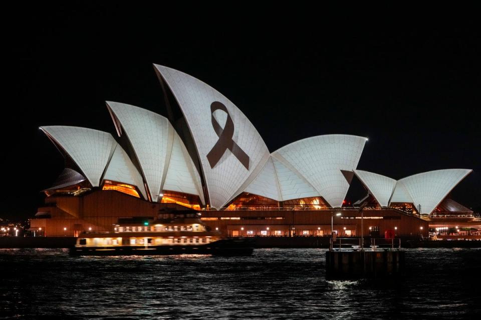 The Sydney Opera House is illuminated with a black ribbon as part of the national day of mourning (AP)