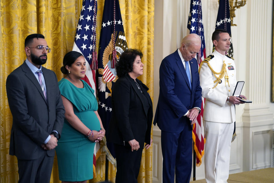 President Joe Biden listens before presenting the Medal of Valor, the nation's highest honor for bravery by a public safety officer, to from right, Gabina Mora (Mother), accepting on behalf of Fallen Detective Wilbert Mora of the New York City Police Dept., Dominique Rivera (Wife), accepting on behalf of Fallen Detective Jason Rivera of the New York City Police Dept., and Detective Sumit Sulan of the New York City Police Dept, during an event in the East Room of the White House, Wednesday, May 17, 2023, in Washington. (AP Photo/Evan Vucci)