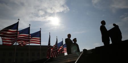 U.S. President Barack Obama (R) speaks during a ceremony marking the 13th anniversary of the 9/11 attacks at the Pentagon in Washington September 11, 2014. REUTERS/Kevin Lamarque